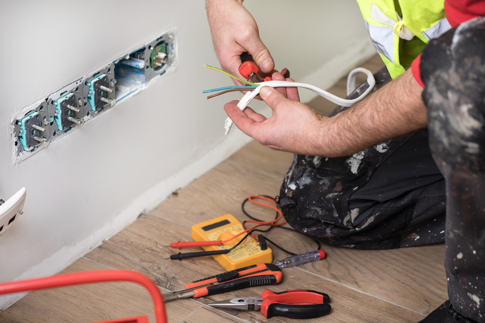 electrician at work, home renovation, electrical installation, Hand of an electrician