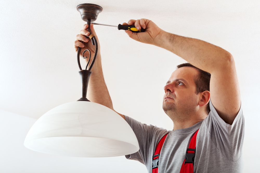 Electrician mounting ceiling lamp - installing the wires mask